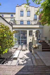 a front view of a house with outdoor seating