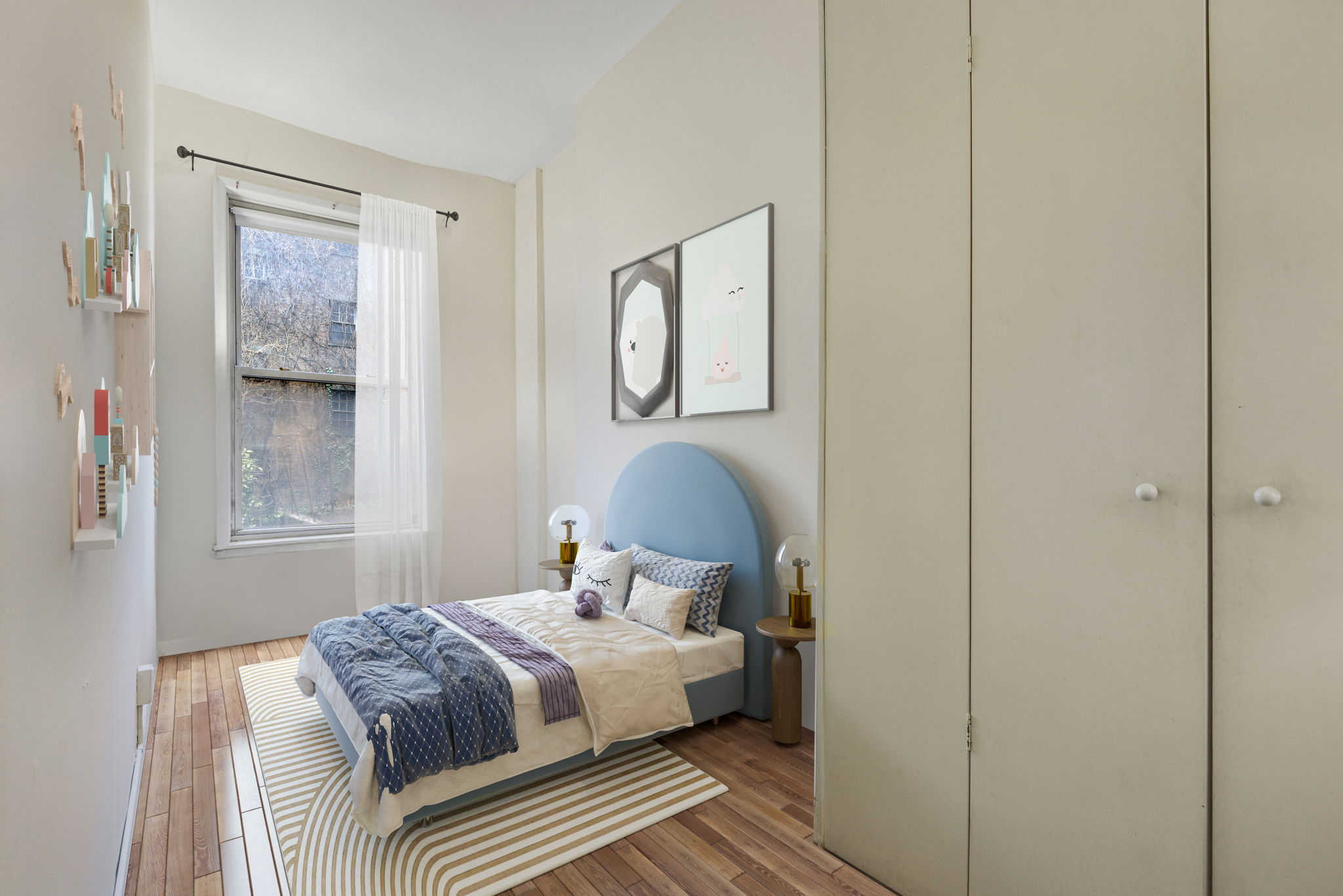 217 West 15th Street Manhattan, NY 10011 - Photo 17 of 21 a bedroom with a bed and window