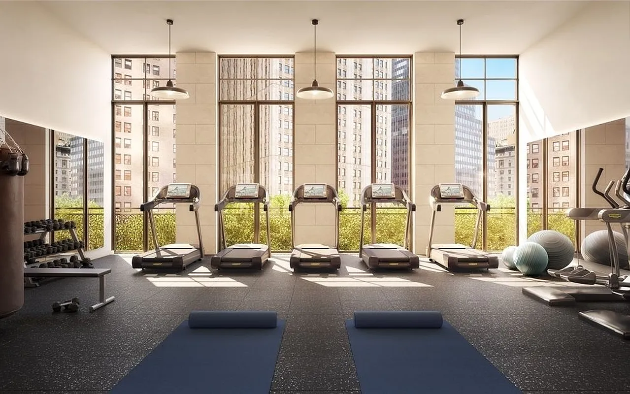 25 Park Row, Unit 11B Manhattan, NY 10038 - Photo 5 of 15 a view of a room with gym equipment and floor to ceiling windows