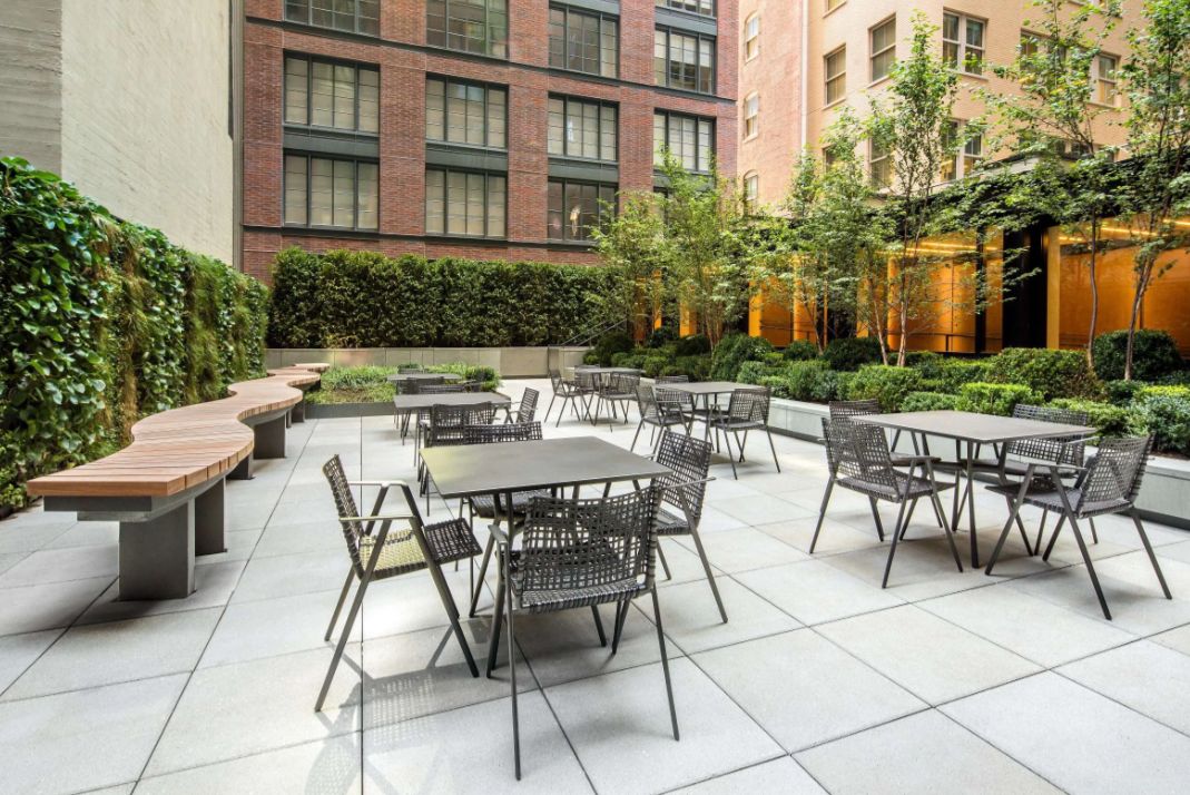 a view of a patio with a table and chairs and potted plants
