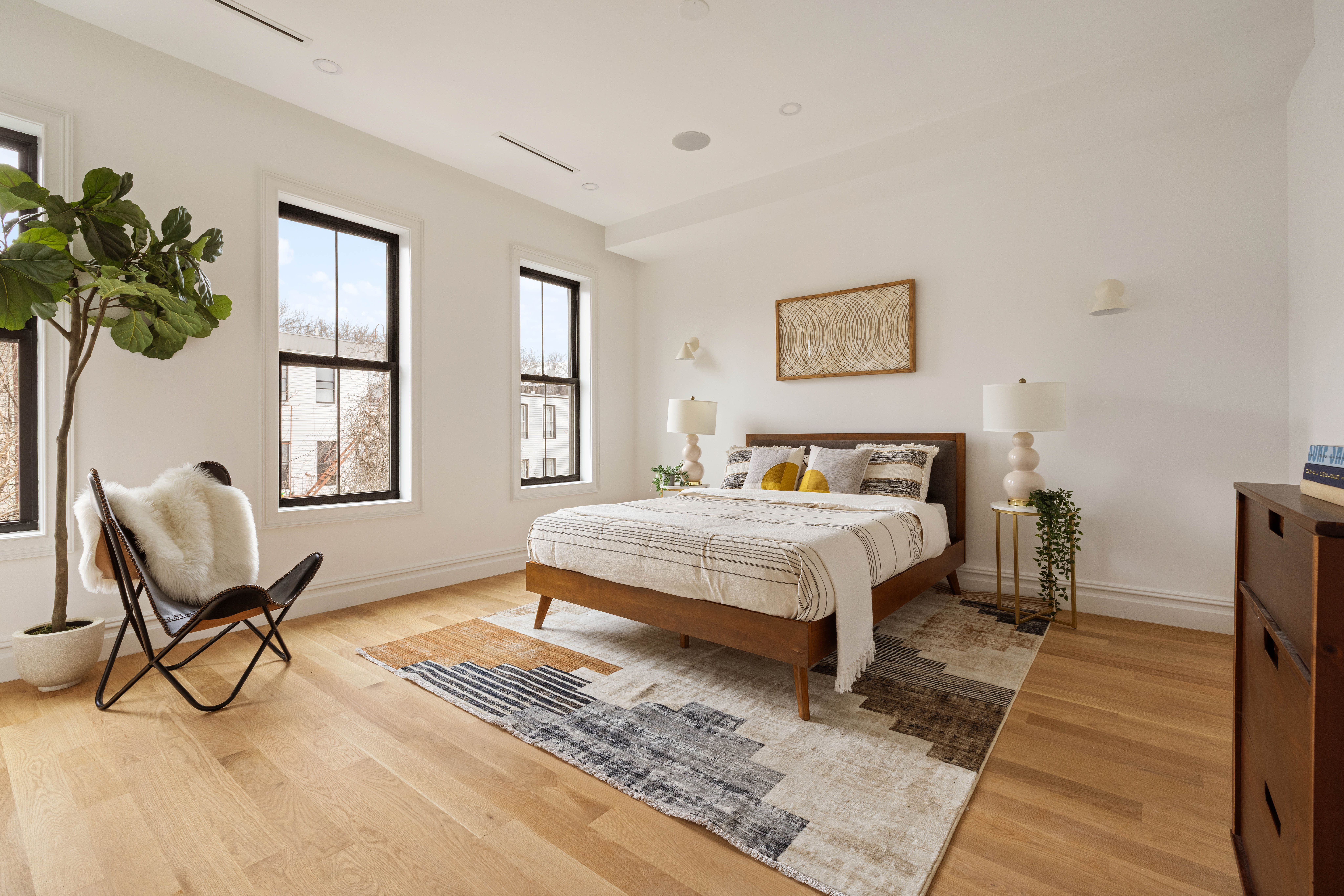 131 Weirfield Street Brooklyn, NY 11221 - Photo 6 of 14 a bedroom with a bed table chair and a window