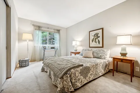 a bedroom with a bed and a painting on the wall
