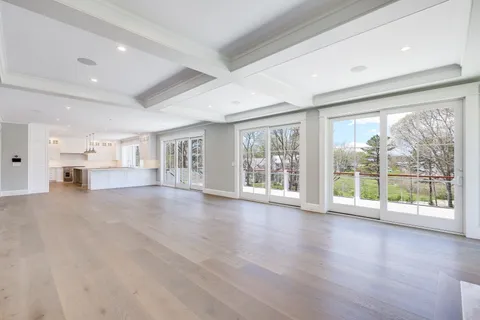 a view of empty room with wooden floor and fireplace