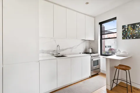 a kitchen with stainless steel appliances granite countertop a sink and cabinets