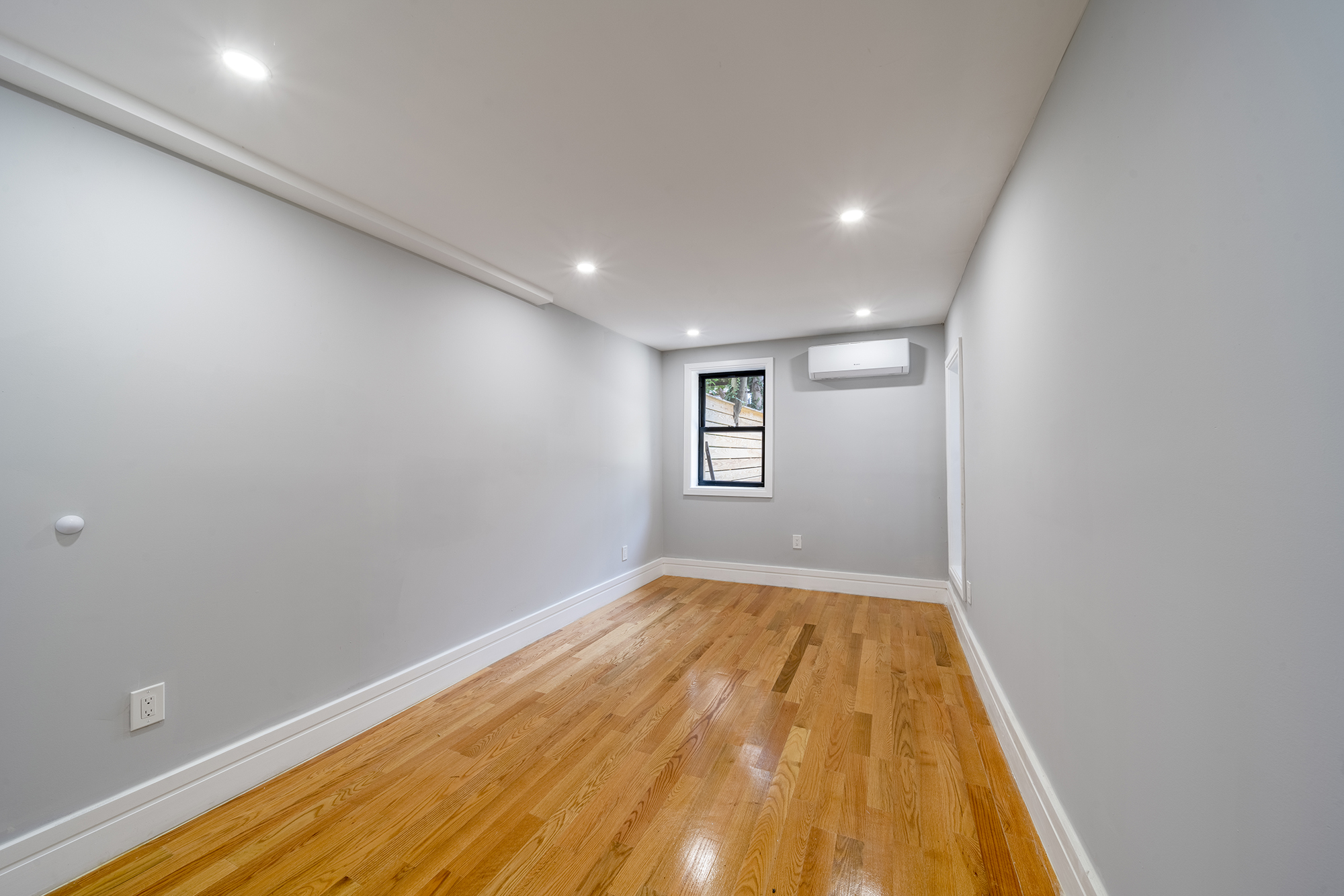 192 Weirfield Street, Unit ONE Brooklyn, NY 11221 - Photo 7 of 8 a view of room with window and wooden floor