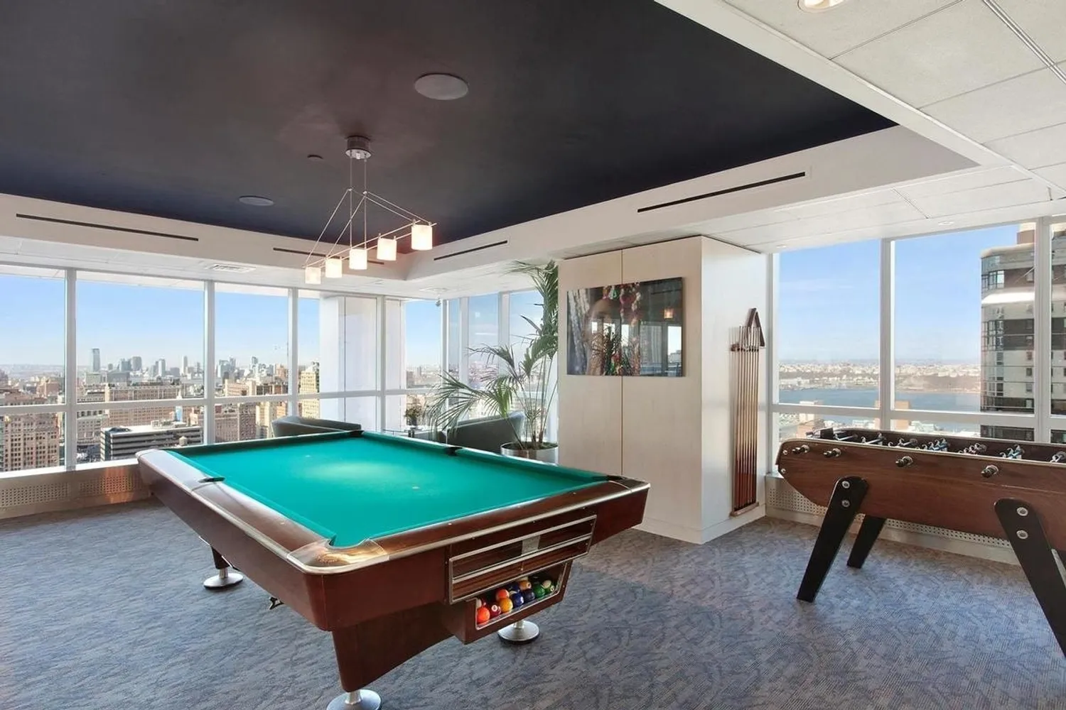 350 West 42nd Street, Unit 27K Manhattan, NY 10036 - Photo 15 of 18 a room with pool table and a large window