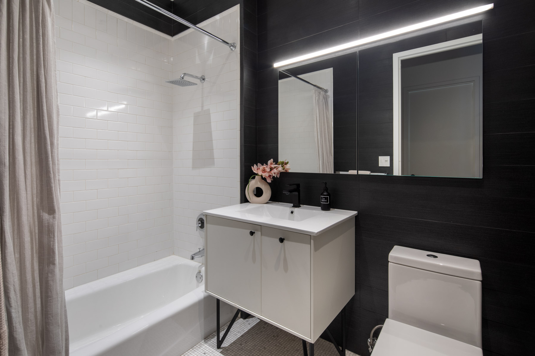 252 7th Avenue, Unit 10X Manhattan, NY 10001 - Photo 14 of 20 a bathroom with a sink and a mirror