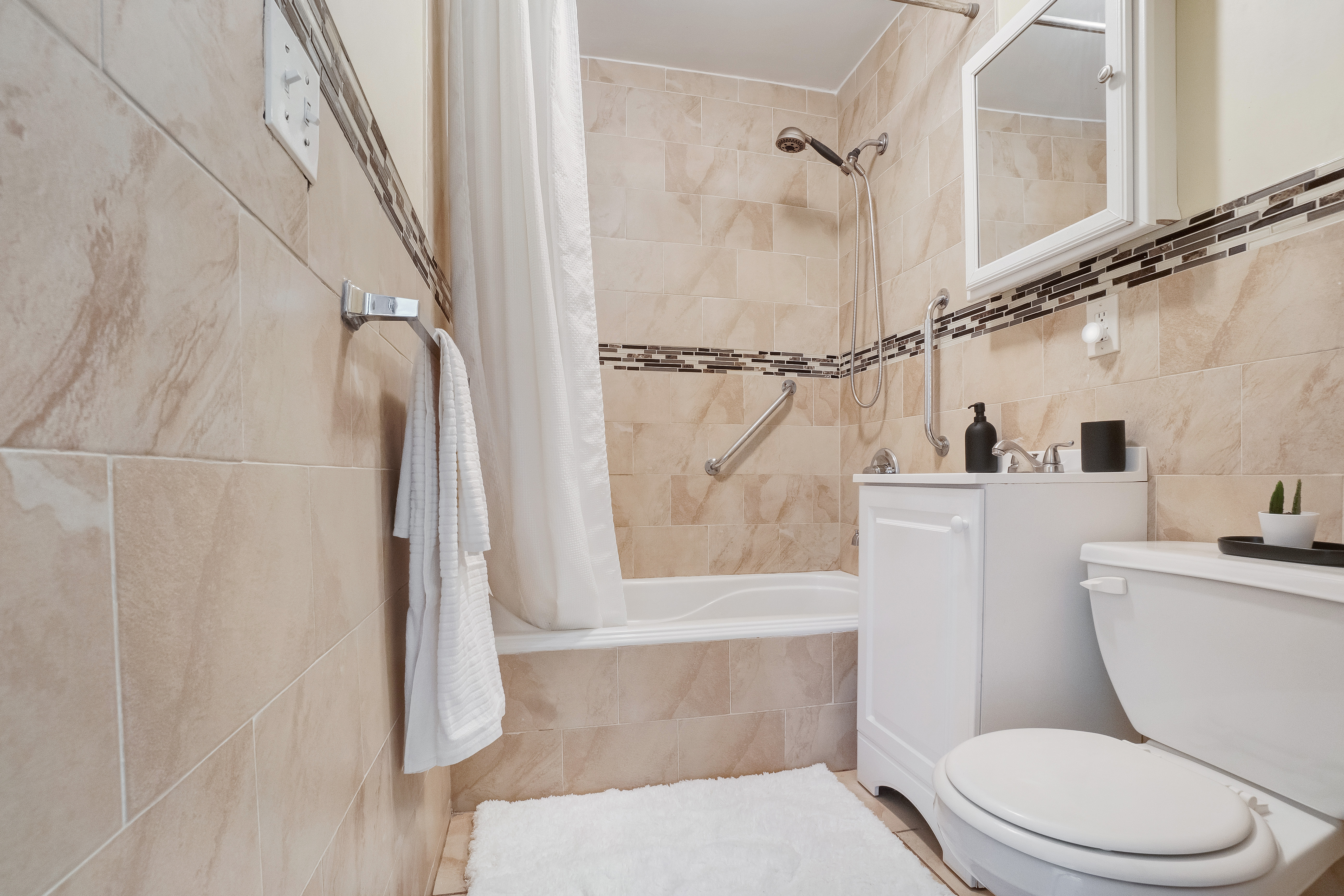 1570 Prospect Place, Unit 3 Brooklyn, NY 11233 - Photo 7 of 10 a white toilet sitting next to a bath tub