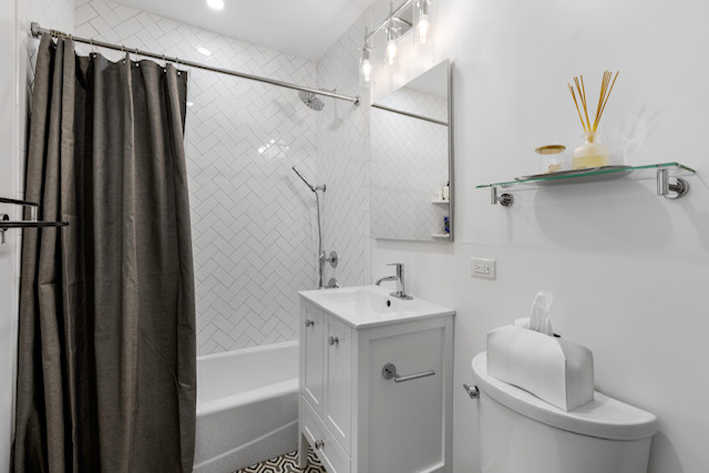 161 Remsen Street, Unit 2C Brooklyn, NY 11242 - Photo 9 of 13 a bathroom with a sink toilet and shower