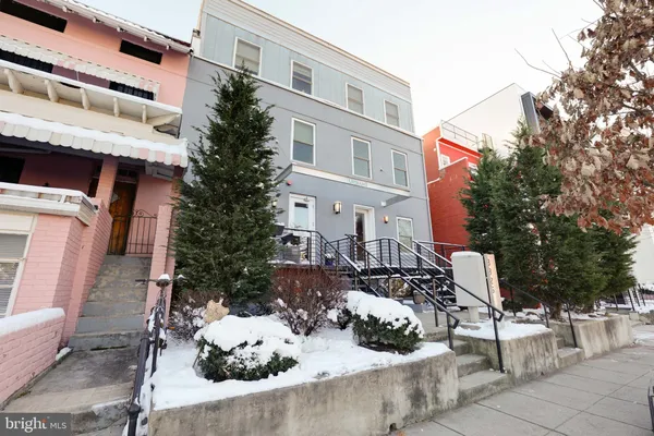a view of a patio with table and chairs potted plants