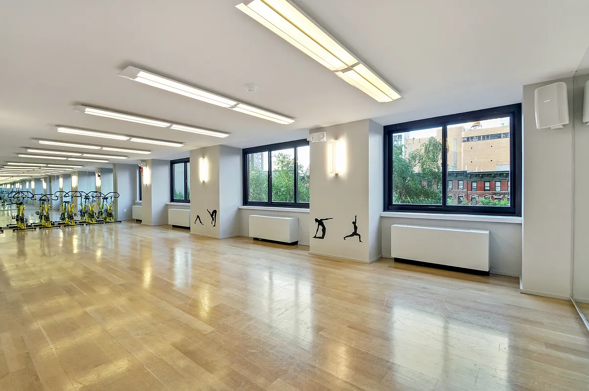 515 East 72nd Street, Unit 40E Manhattan, NY 10021 - Photo 31 of 34 a living room with a large window and furniture