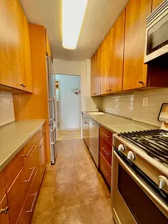 a kitchen with wooden cabinets and a stove top oven