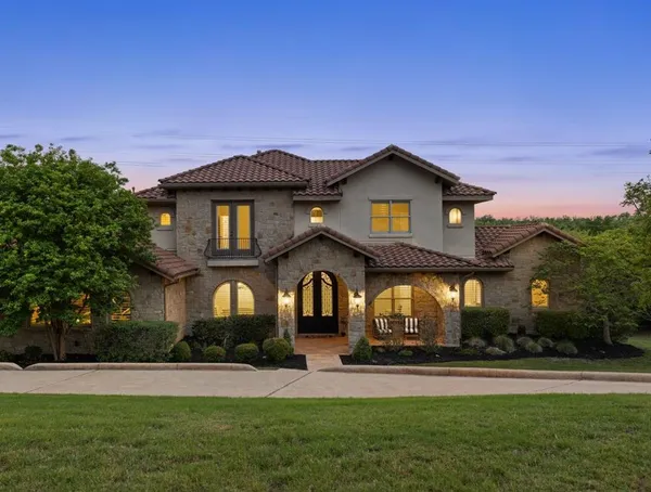 a kitchen with stainless steel appliances granite countertop a stove top oven a sink a dining table and chairs