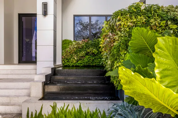 a front view of a house with a garden