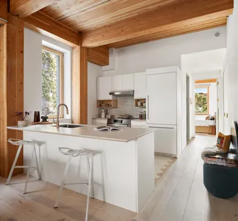 a kitchen with stainless steel appliances kitchen island granite countertop a sink and cabinets
