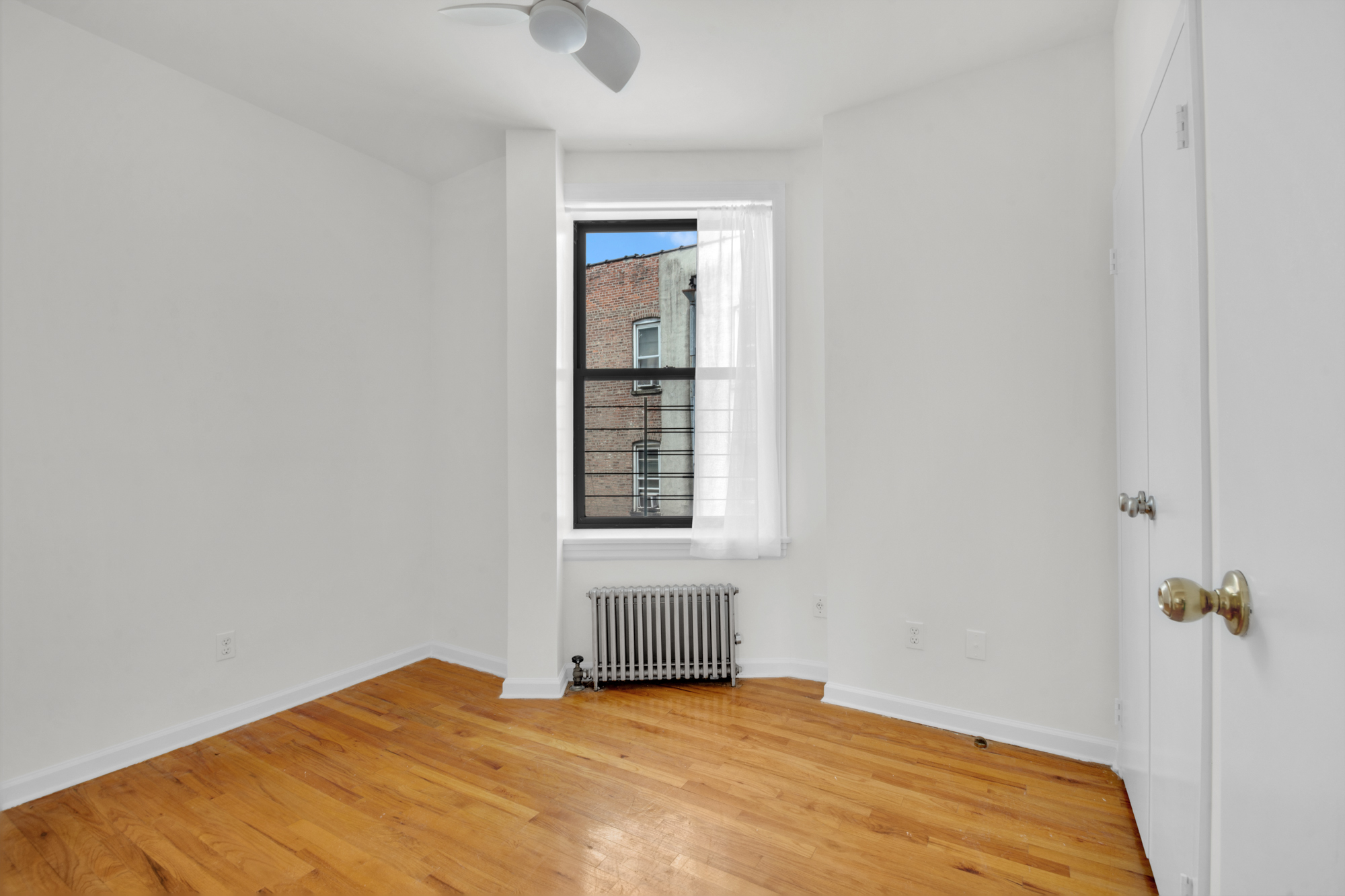 469 West 166th Street, Unit 4C Manhattan, NY 10032 - Photo 9 of 12 a view of a bedroom with a window