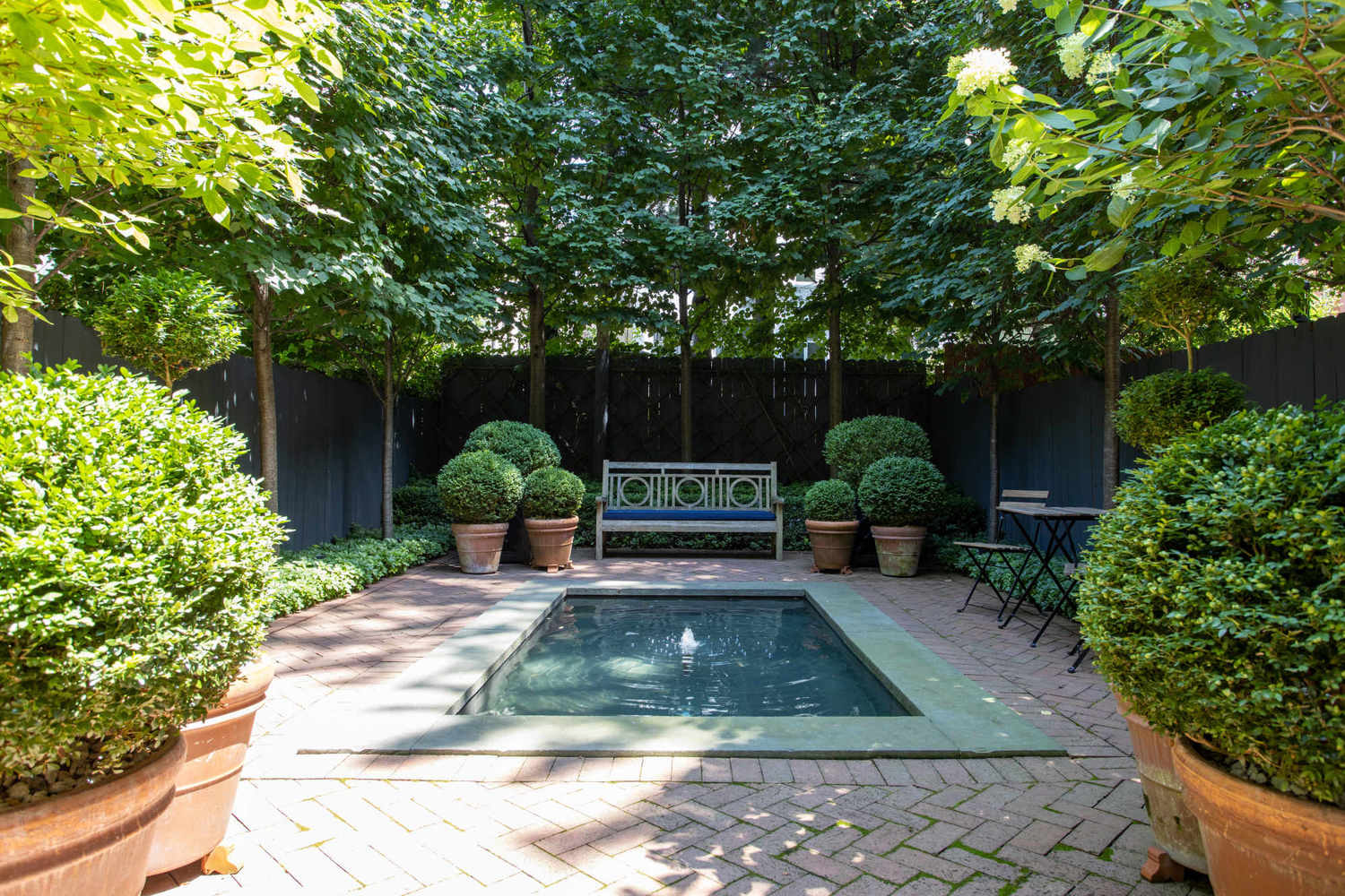 315 Adelphi Street Brooklyn, NY 11205 - Photo 11 of 31 a view of a backyard with table and chairs potted plants and large tree