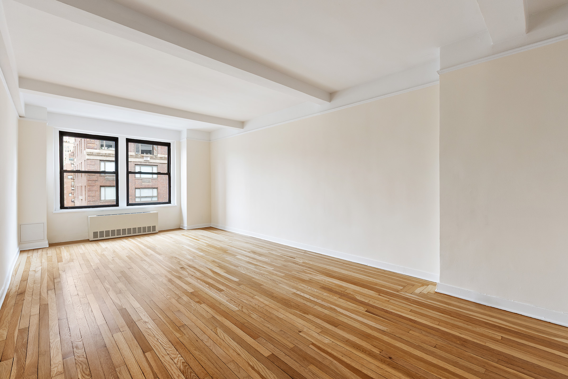 205 East 78th Street, Unit 14C Manhattan, NY 10075 - Photo 7 of 12 wooden floor in an empty room with a window