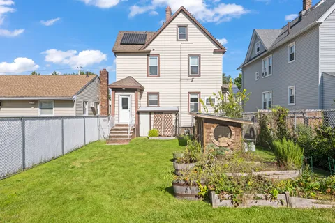 a view of a house with backyard and porch