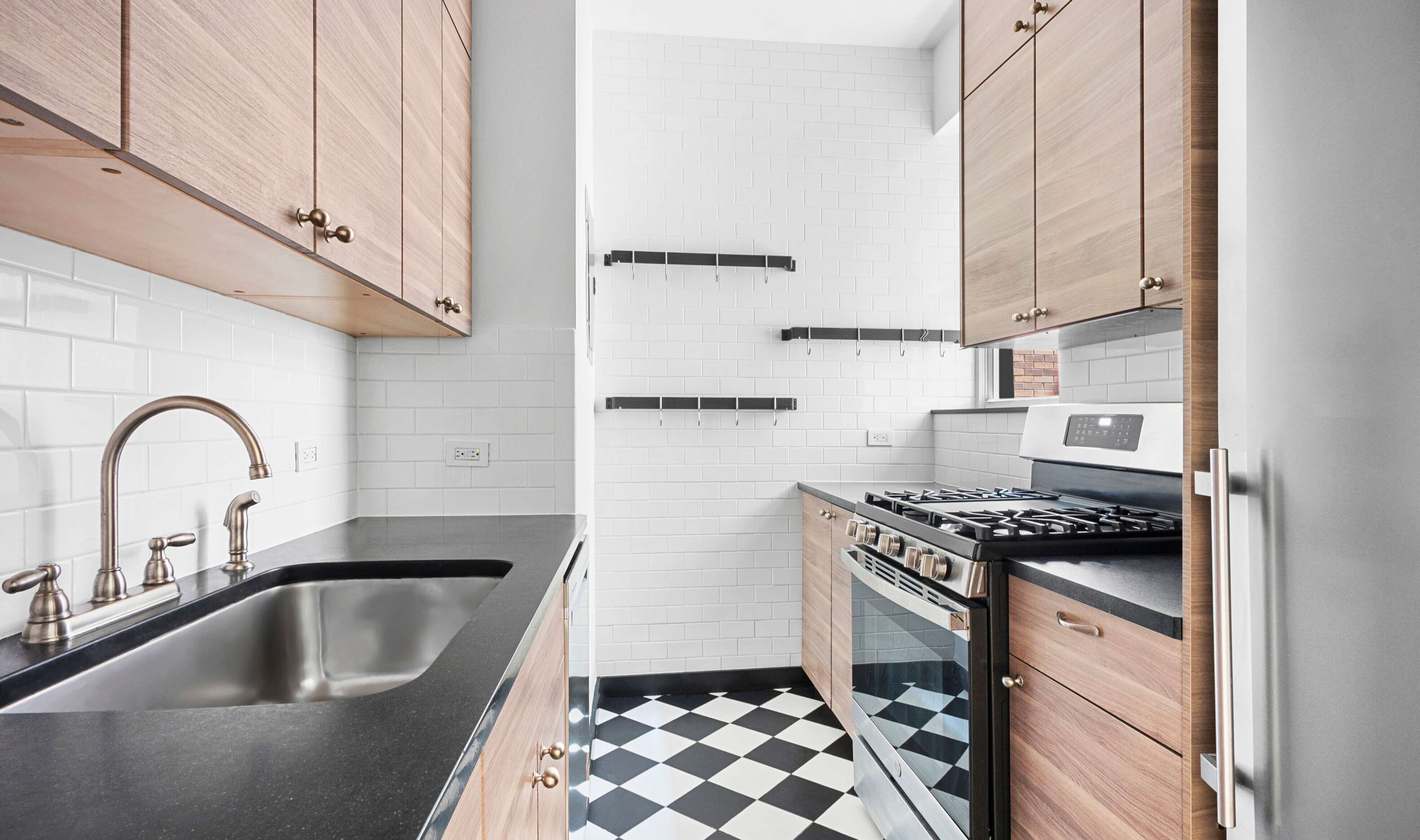 464 Columbus Avenue, Unit 3B Manhattan, NY 10024 - Photo 5 of 8 a kitchen with granite countertop a sink and cabinets