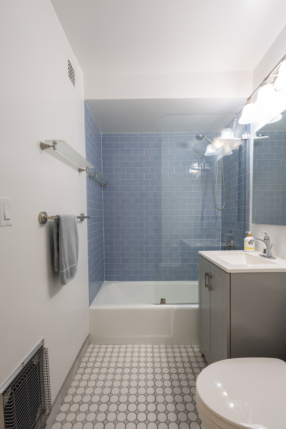 130 West 67th Street, Unit 26D Manhattan, NY 10023 - Photo 7 of 9 a bathroom with a sink a toilet and shower