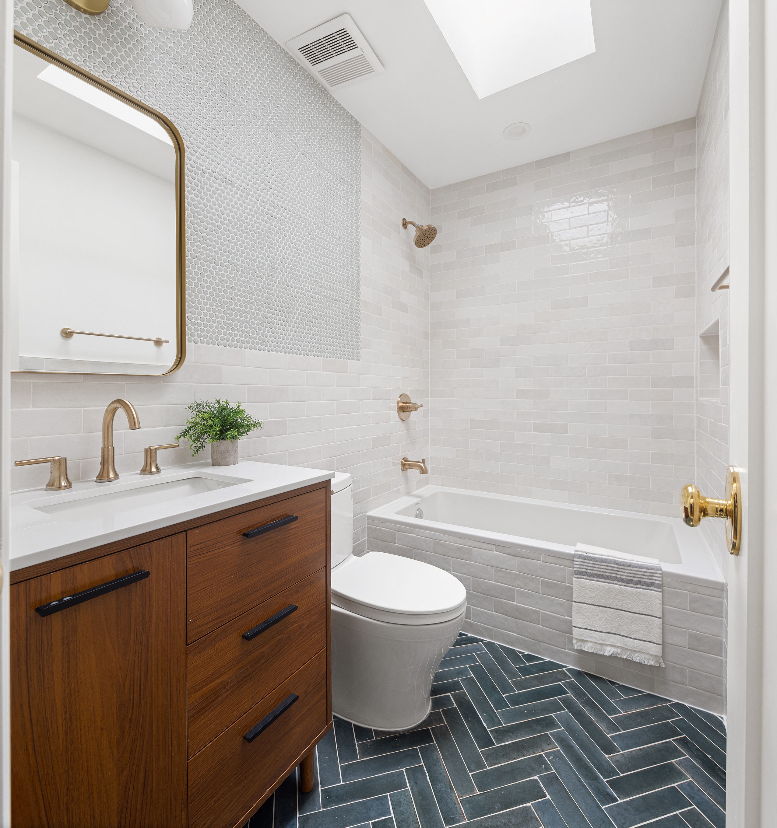 363 Warren Street Brooklyn, NY 11201 - Photo 16 of 23 a bathroom with a granite countertop toilet a sink and a mirror
