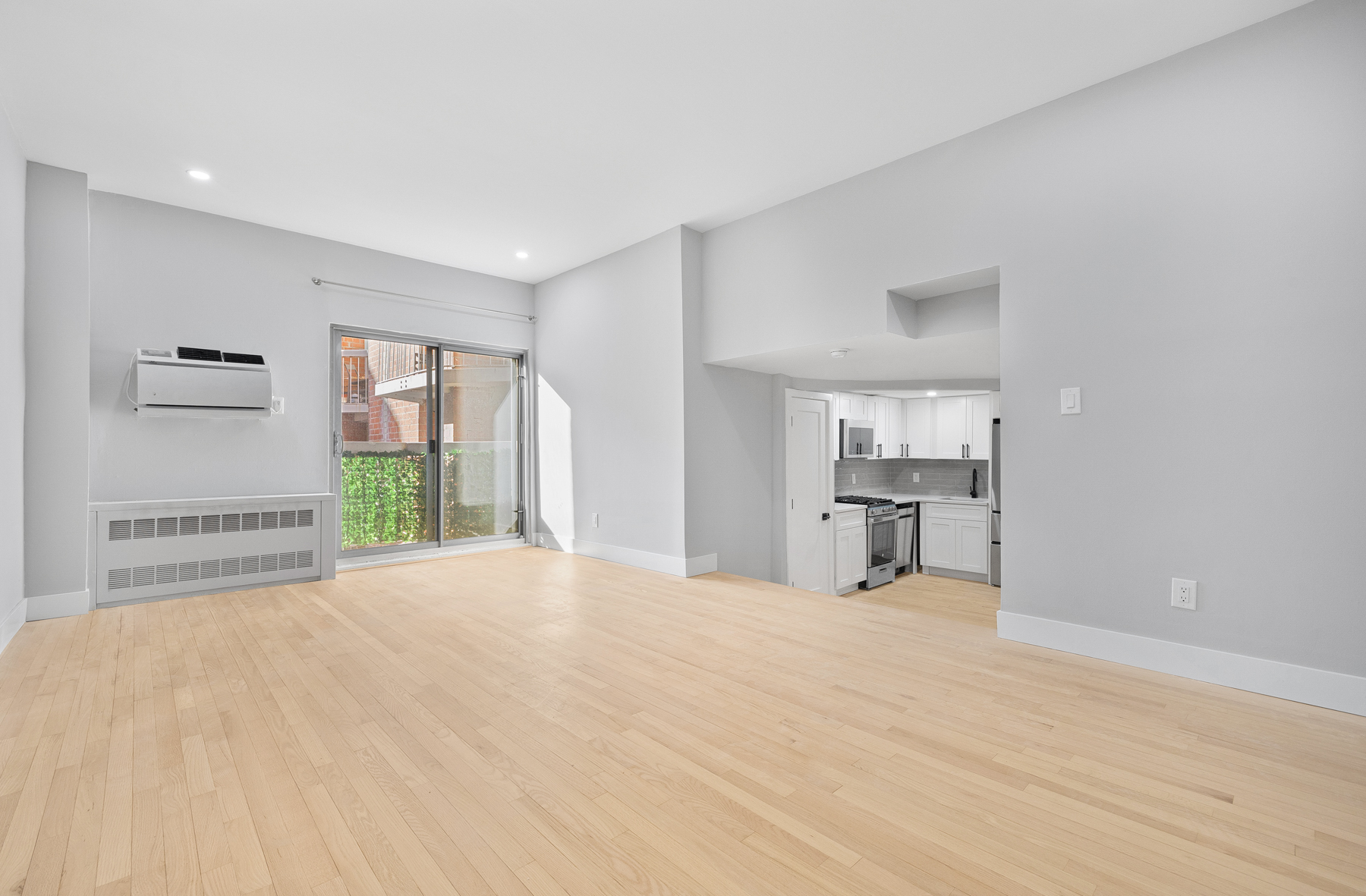 184 Thompson Street, Unit 2V Manhattan, NY 10012 - Photo 2 of 8 a view of empty room with wooden floor and fan