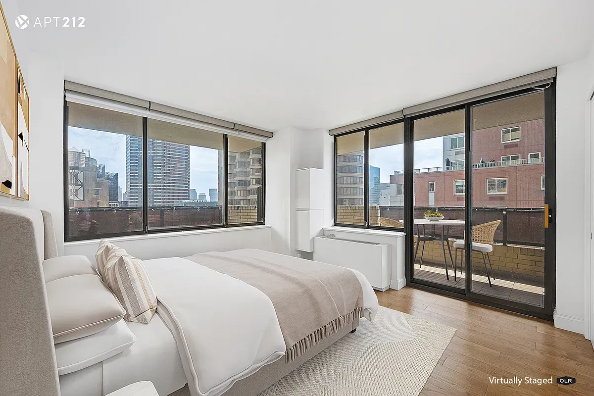 a bedroom with a large bed and a large window