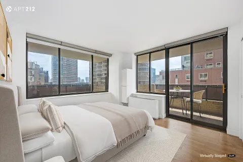 a bedroom with a large bed and a large window