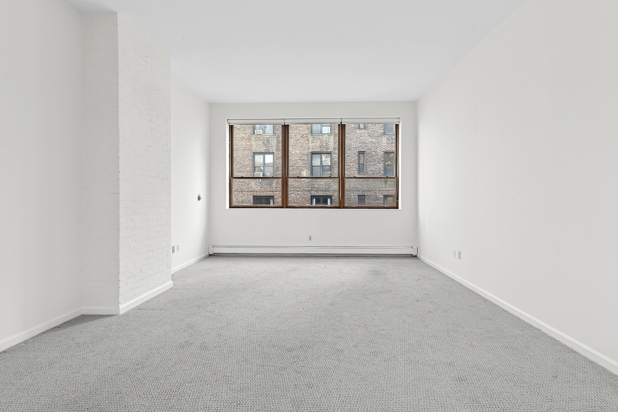 215 West 22nd Street, Unit 2 Manhattan, NY 10011 - Photo 2 of 8 an empty room with windows