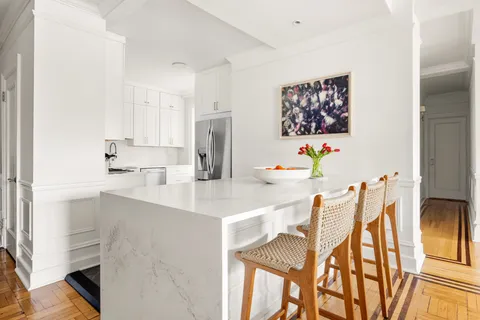 a kitchen with a table chairs and a refrigerator