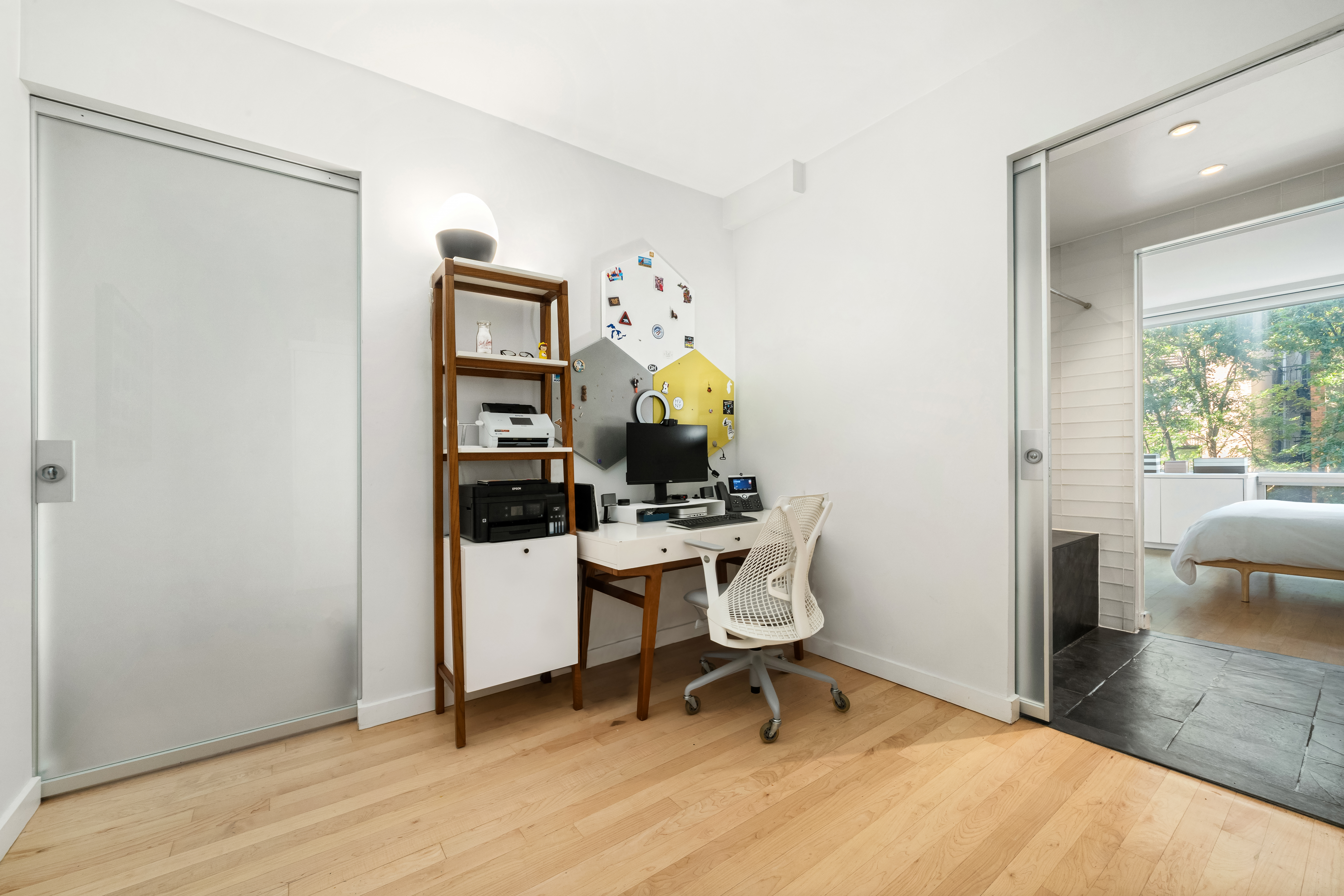 425 East 13th Street, Unit 4C Manhattan, NY 10009 - Photo 8 of 14 a view of a workspace with furniture and a window