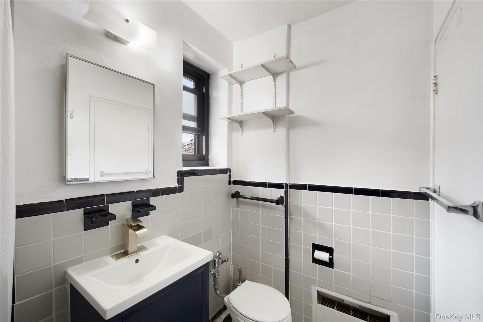 73-11 Bell Boulevard, Unit 2C Queens, NY 11364 - Photo 15 of 16 a bathroom with a sink toilet and shower