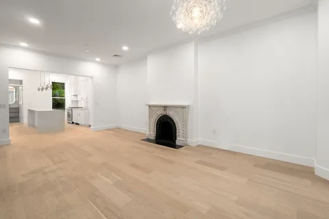 a view of a livingroom with furniture and a refrigerator