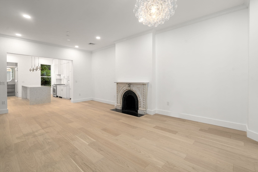 34 Worcester Square, Unit 2 Boston, MA 02118 - Photo 7 of 18 a view of empty room with fireplace and fan