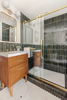 a bathroom with a mirror and a shower
