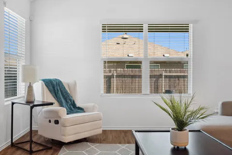 a view of living room with furniture and potted plant