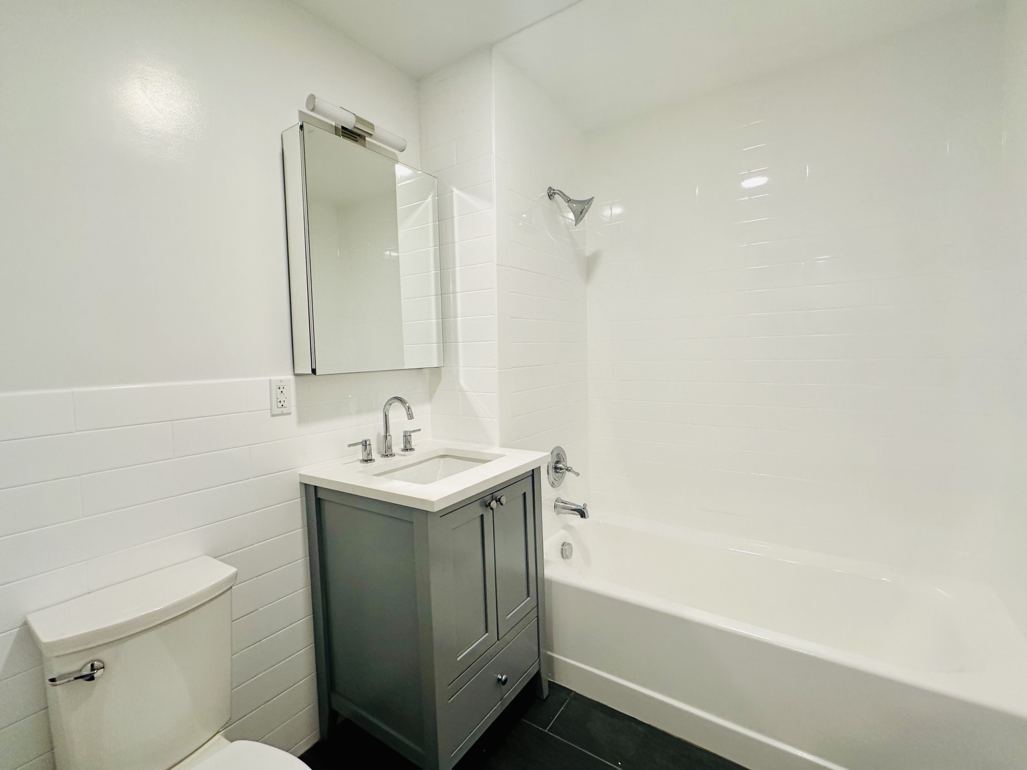 23 Bleecker Street, Unit 4E Brooklyn, NY 11221 - Photo 6 of 11 a bathroom with a sink a toilet and shower