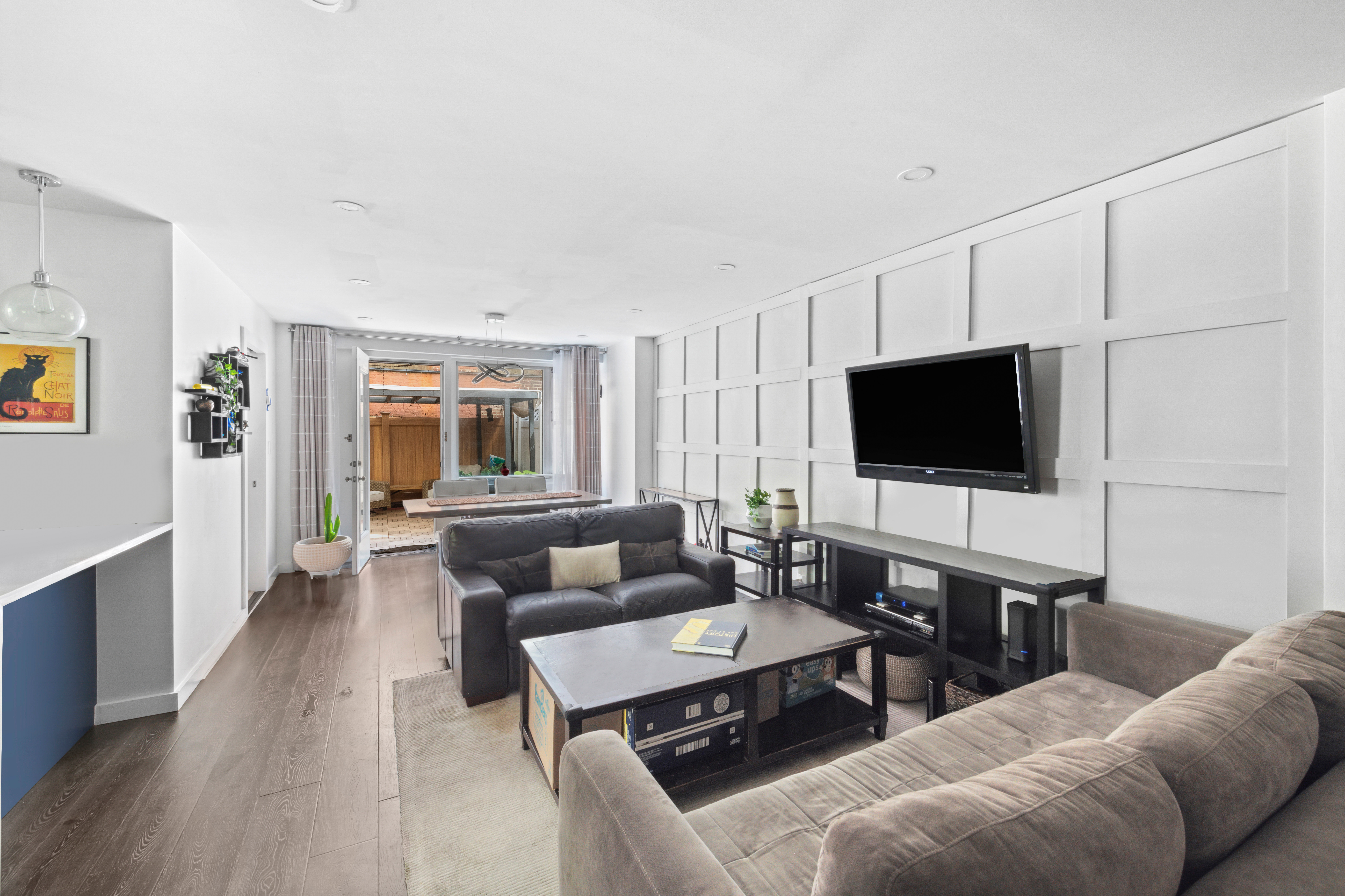 400 East 77th Street, Unit 1CD Manhattan, NY 10075 - Photo 4 of 18 a living room with furniture and a flat screen tv