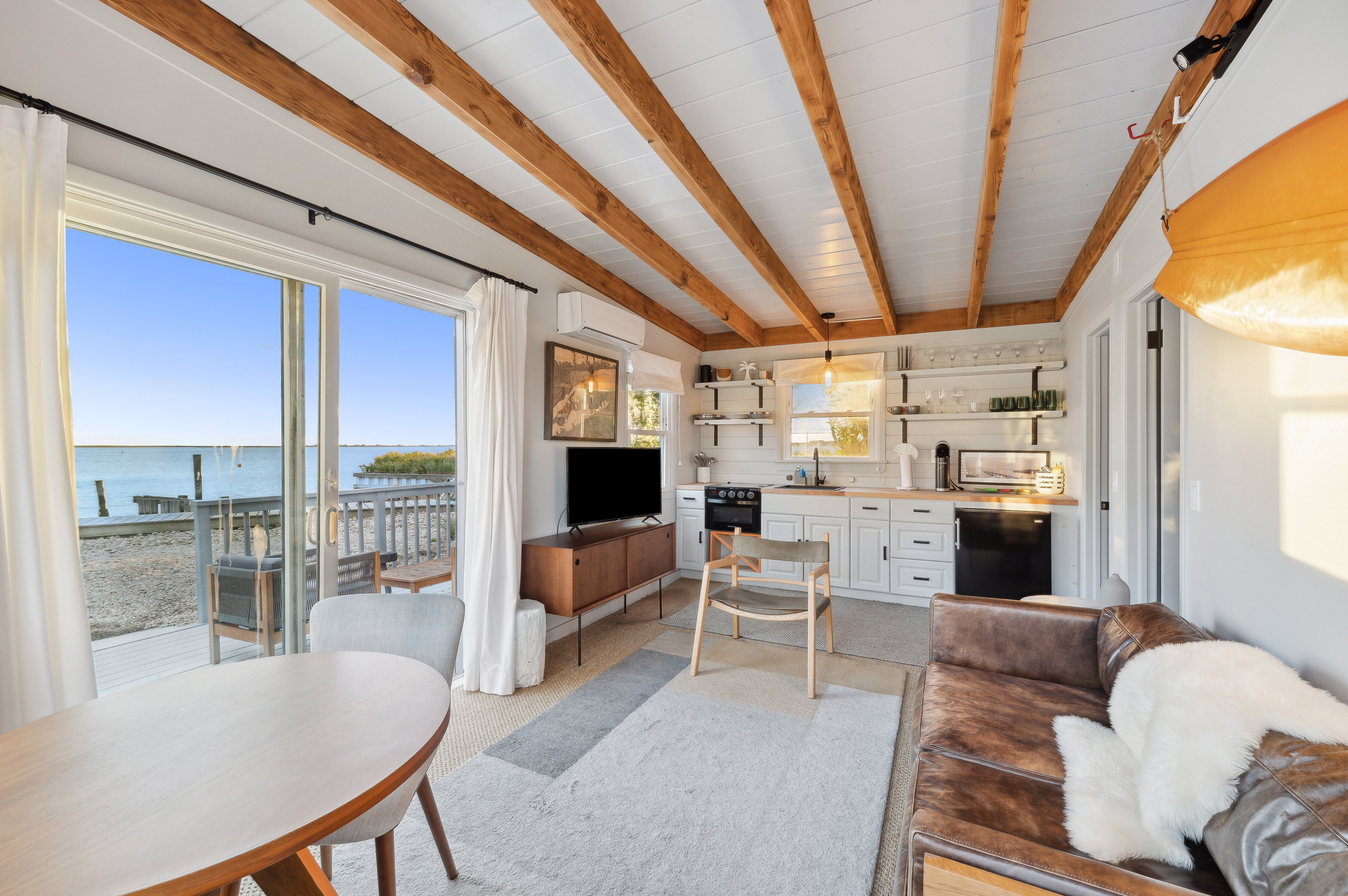 32 Lighthouse Road Hampton Bays, NY 11946 - Photo 40 of 51 a living room with furniture and a flat screen tv