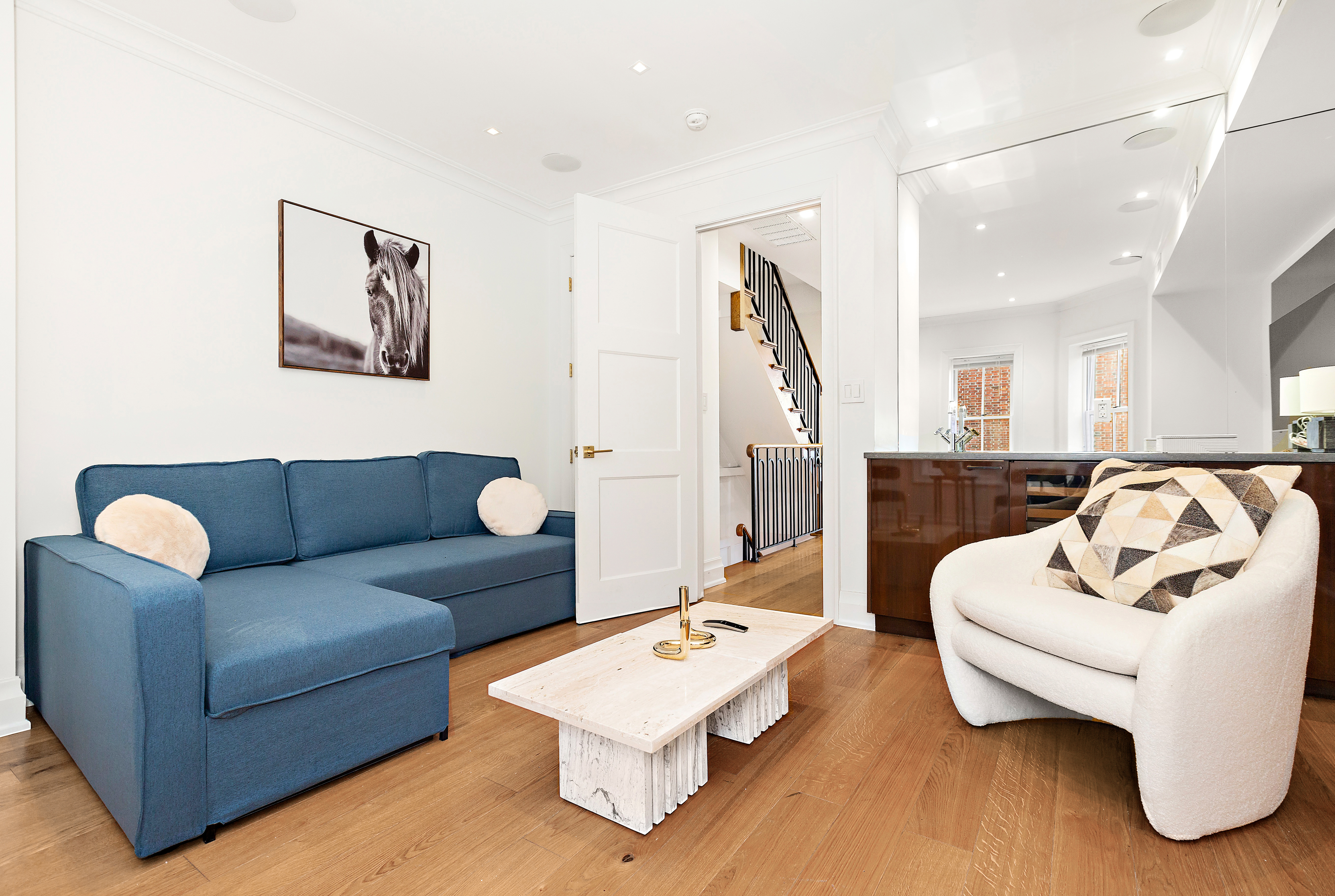 134 East 36th Street Manhattan, NY 10016 - Photo 16 of 28 a living room with furniture and a wooden floor