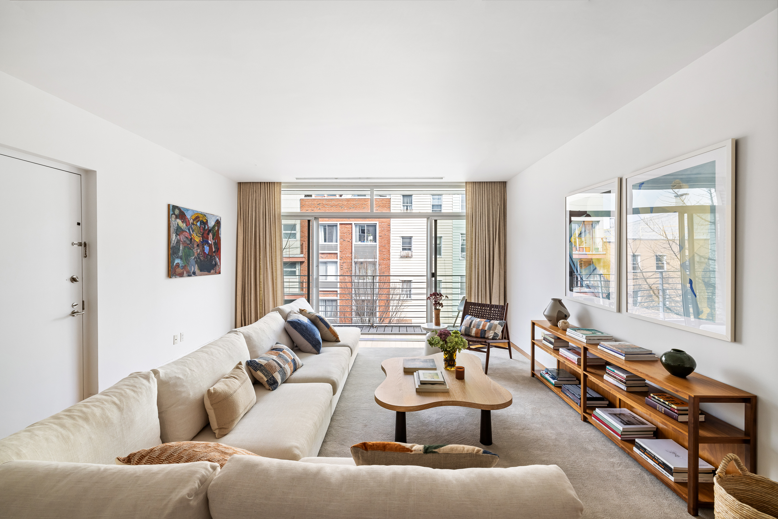 361 Manhattan Avenue, Unit 3AB Brooklyn, NY 11211 - Photo 17 of 21 a living room with furniture and a large window