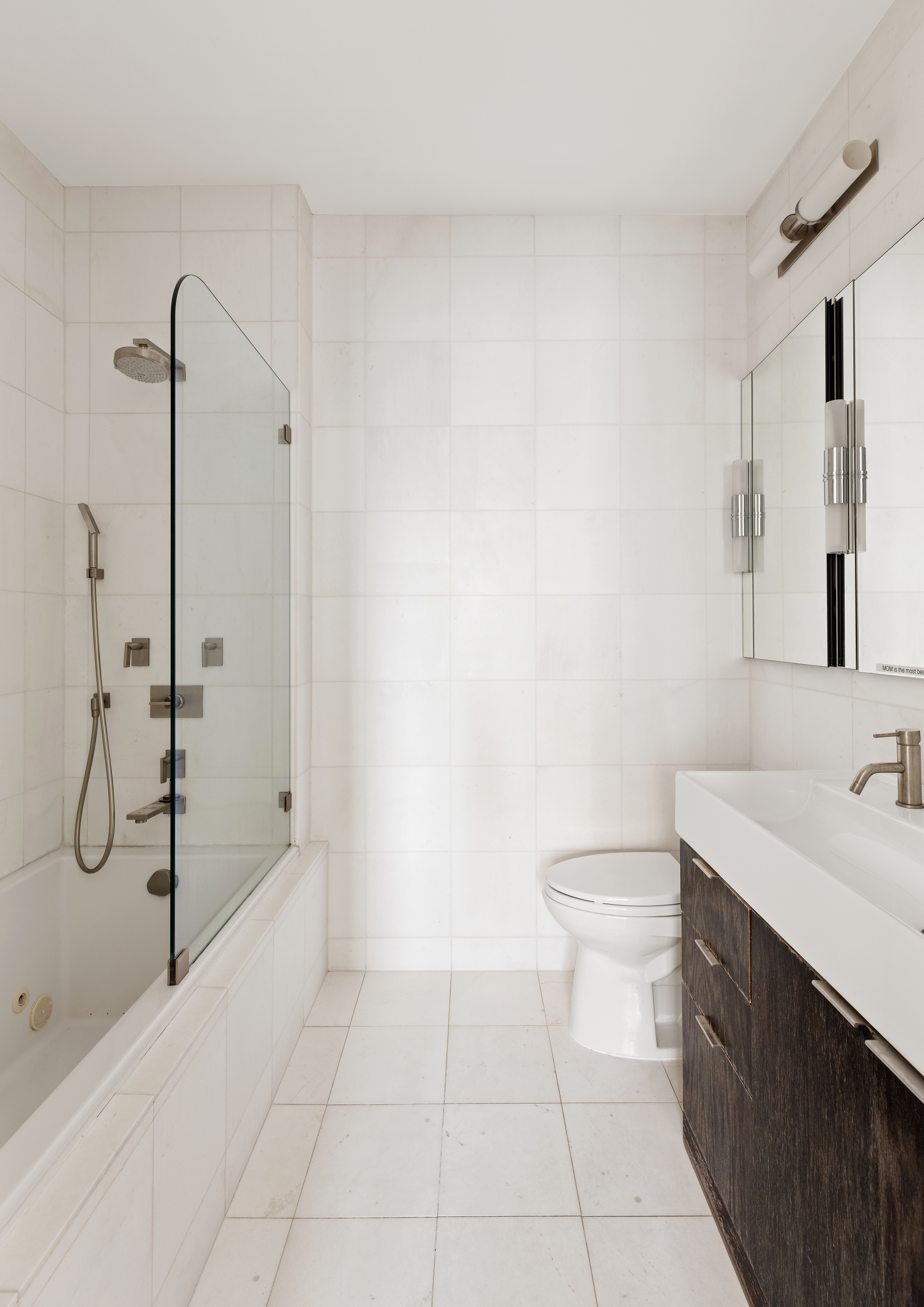 524 East 72nd Street, Unit 28DE Manhattan, NY 10021 - Photo 4 of 14 a bathroom with a granite countertop sink a toilet and a shower