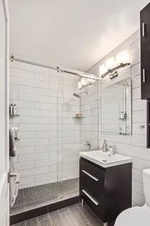 a spacious bedroom with a bed and a large window