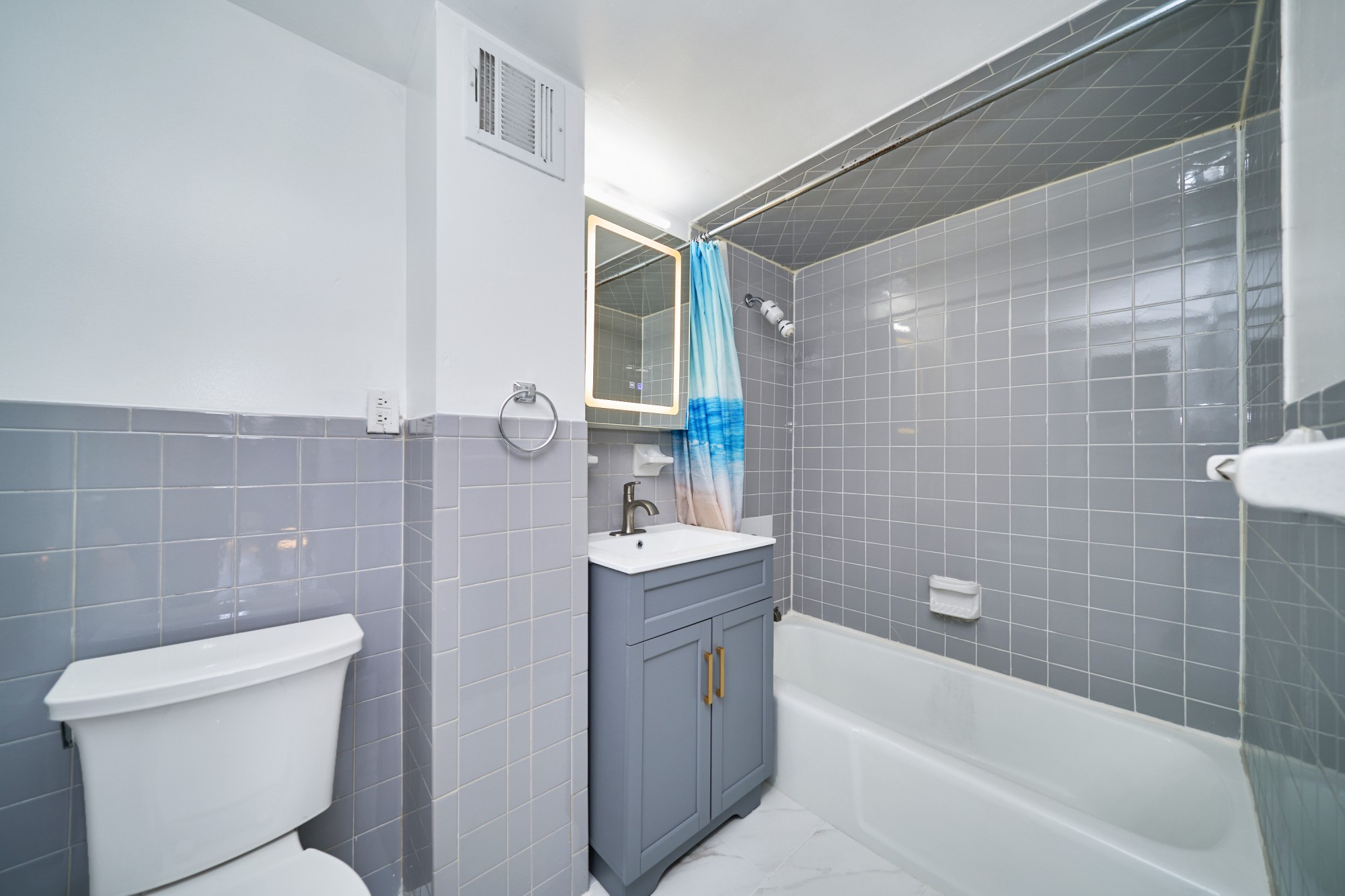 357 West 120th Street, Unit 2F Manhattan, NY 10027 - Photo 8 of 8 a bathroom with a sink mirror toilet and bathtub