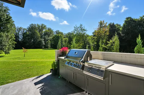 a bedroom with a bed a flat screen tv and a fireplace