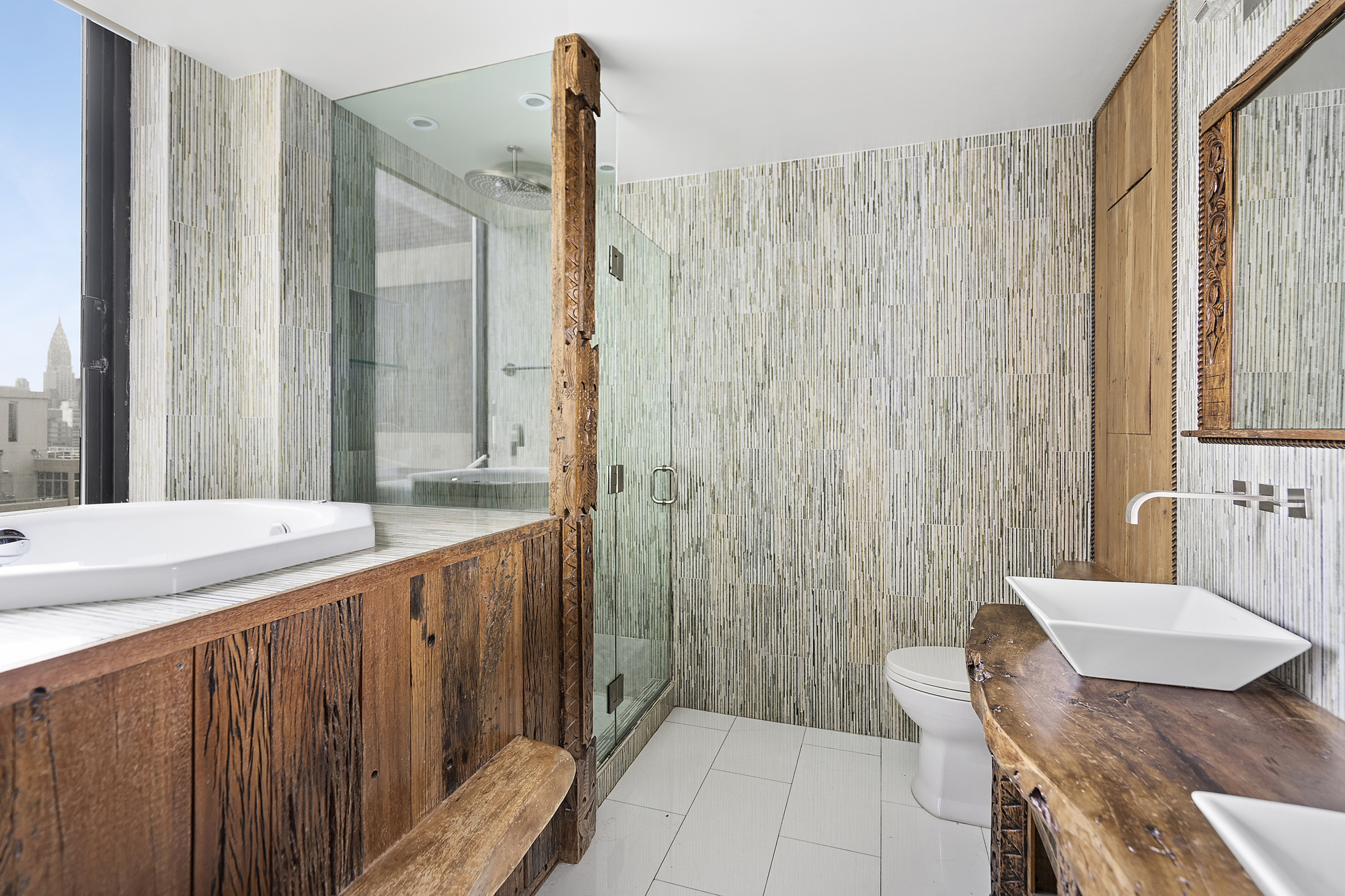 418 East 59th Street, Unit 35A Manhattan, NY 10022 - Photo 5 of 7 a bathroom with a granite countertop sink and a mirror