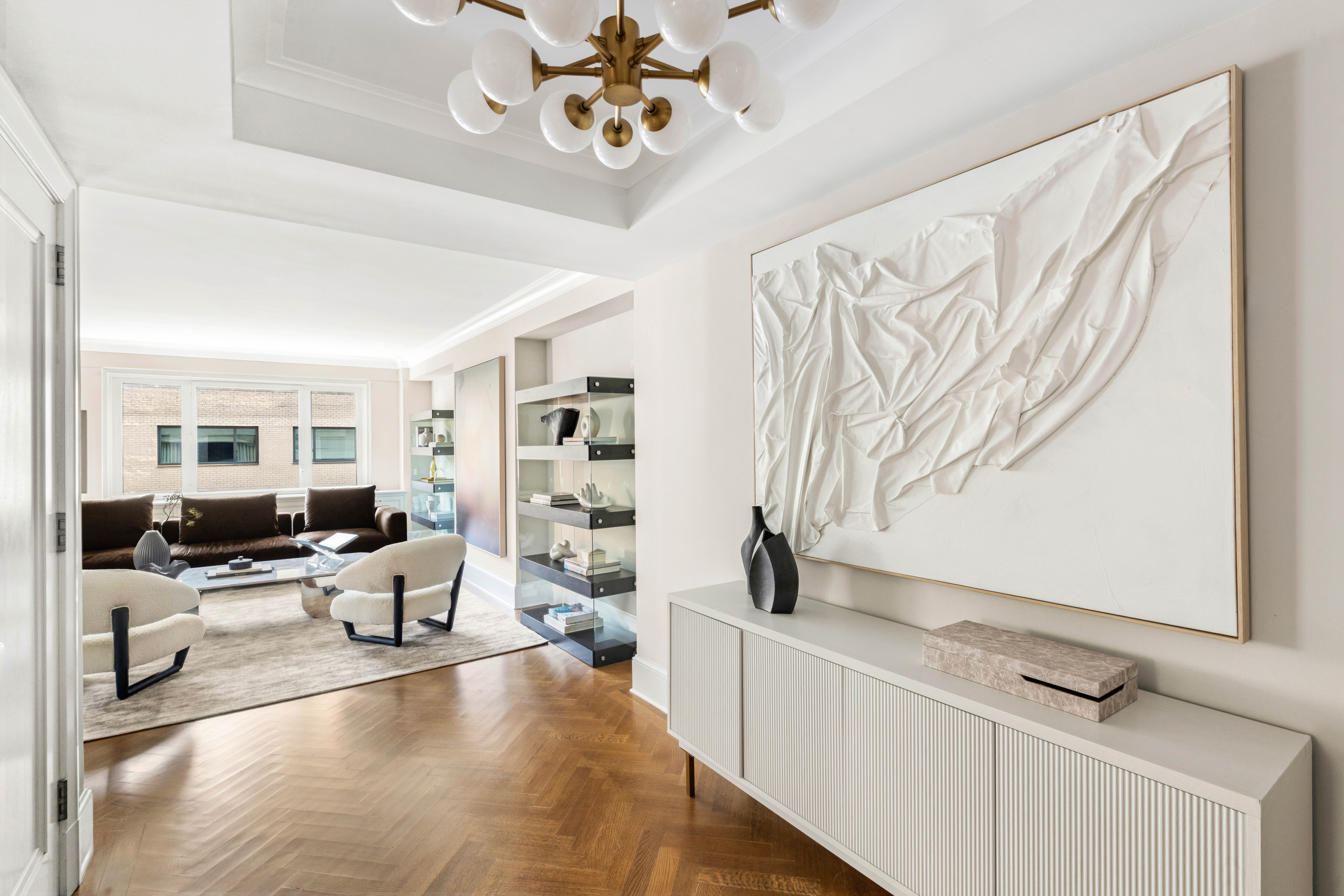 530 Park Avenue, Unit 12F Manhattan, NY 10065 - Photo 3 of 26 a living room with furniture and a flat screen tv