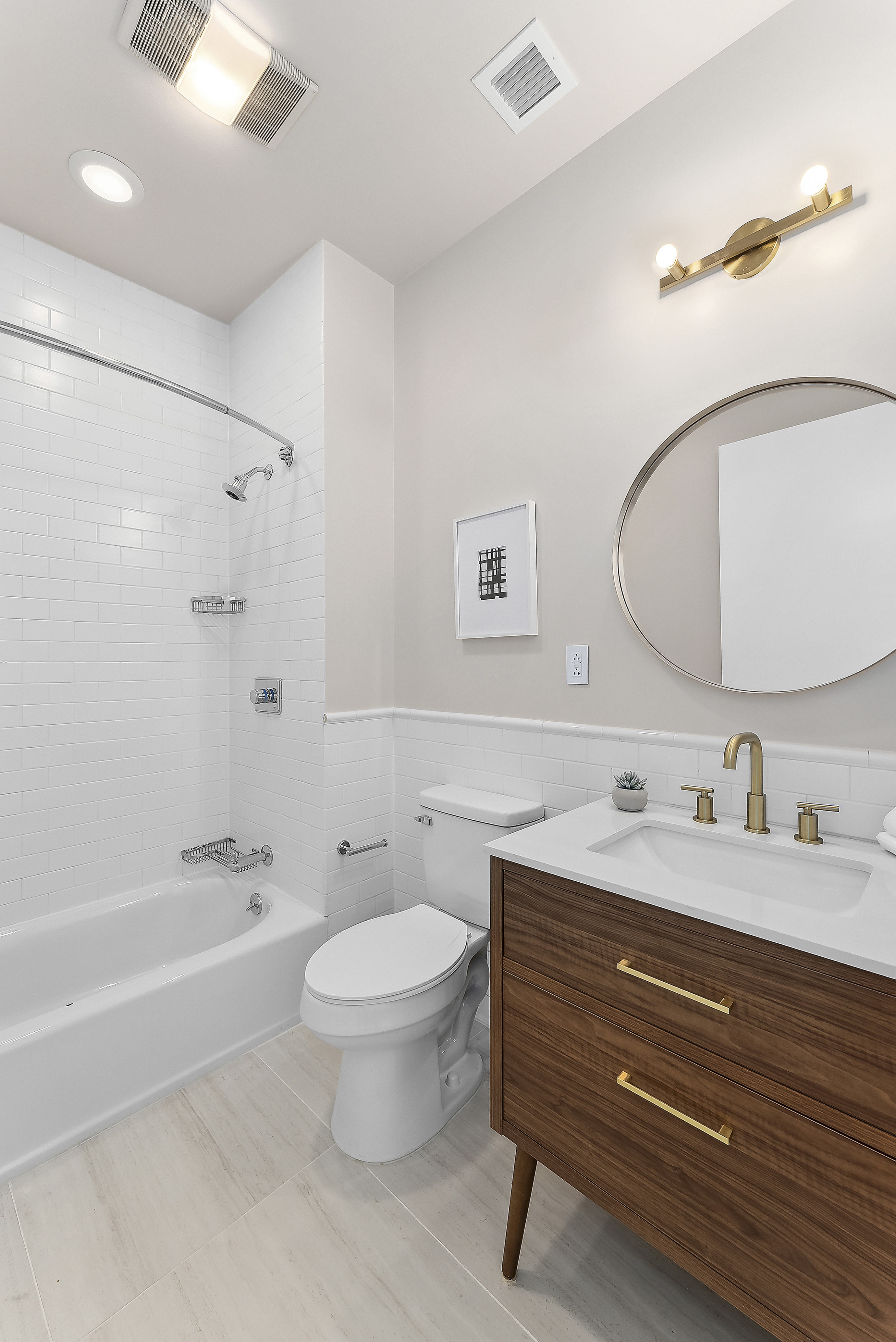 224 West 18th Street, Unit PHA Manhattan, NY 10011 - Photo 21 of 24 a bathroom with a toilet a sink a mirror a bathtub and vanity