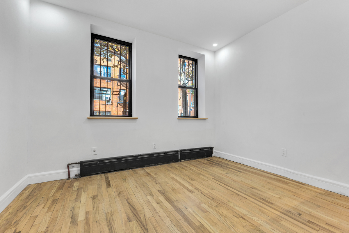 574 Gates Avenue Brooklyn, NY 11221 - Photo 11 of 16 an empty room with windows